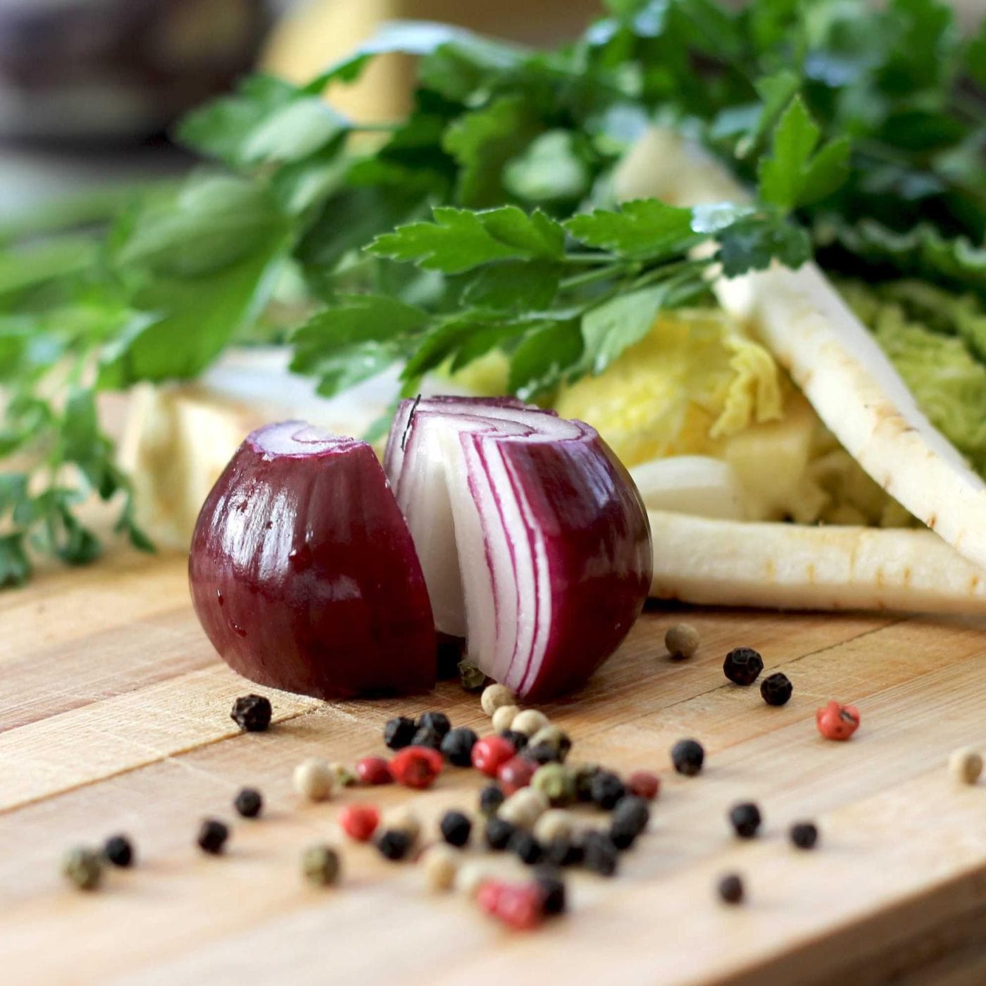 Fresh vegetables and spices laid out on a restaurant cutting board